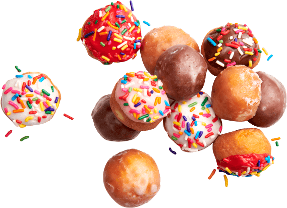 A pile of donuts with sprinkles on top.